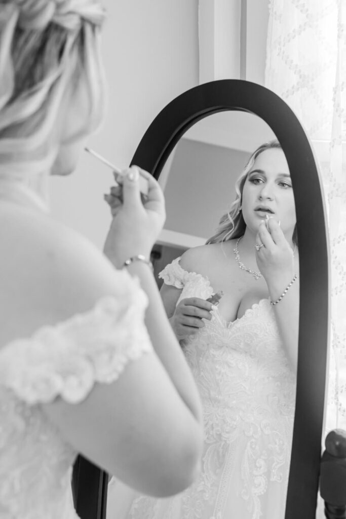 Jackson's Landing Wedding Bride applying lipstick in mirror