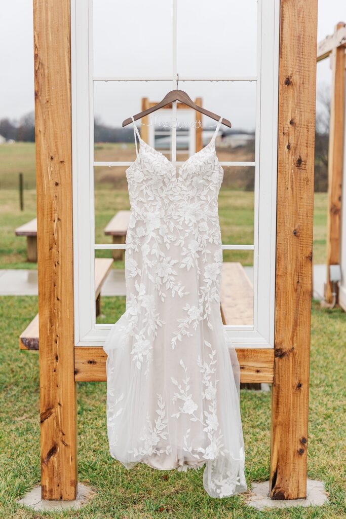 wedding dress hanging from a window pane