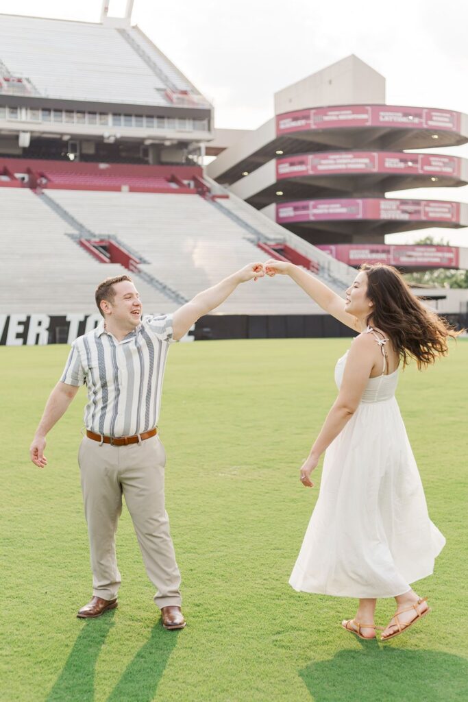 Williams-Brice Stadium Engagement Session couple dancing on the field