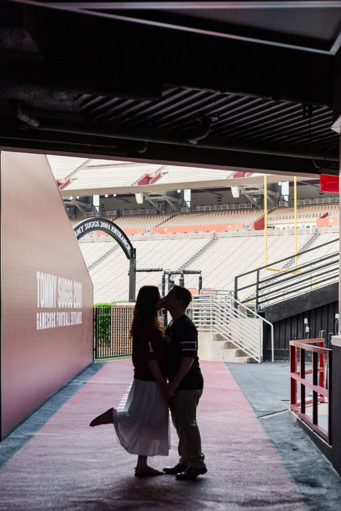 Williams-Brice Stadium Engagement Session couple kissing in tunnel
